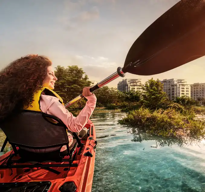 woman kayaking infront of offplan property Abu Dhabi